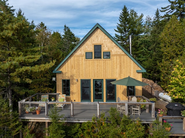 back of house featuring a wooden deck