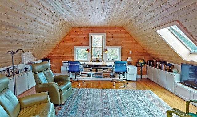 office with vaulted ceiling with skylight, light wood finished floors, wooden ceiling, and wooden walls