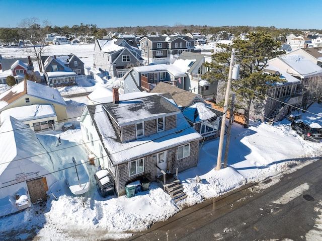 snowy aerial view featuring a residential view