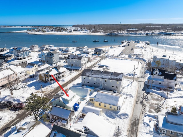 snowy aerial view featuring a water view