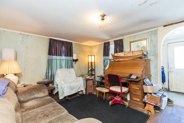 interior space with arched walkways and crown molding