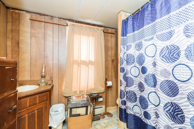 full bathroom with tile patterned floors, a baseboard heating unit, and vanity