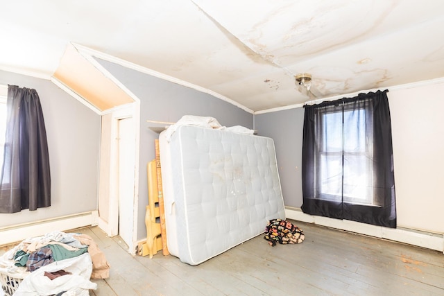 bedroom featuring light wood-type flooring and crown molding