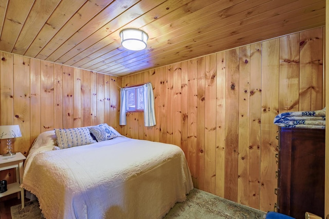 bedroom featuring wooden ceiling and wood walls