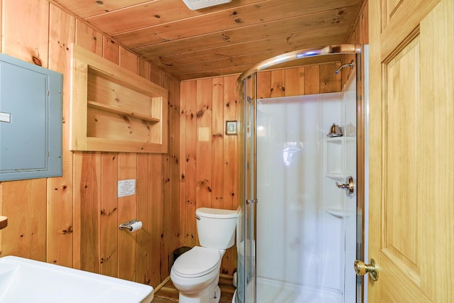 bathroom with electric panel, a stall shower, wood walls, wooden ceiling, and toilet