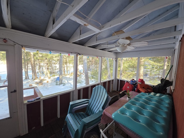 sunroom with lofted ceiling and a ceiling fan