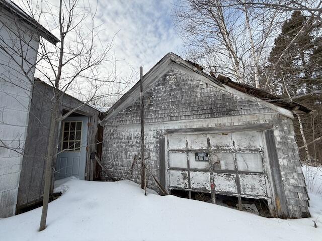 exterior space with an outbuilding and a garage