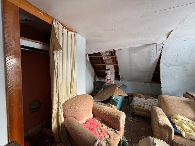 living area featuring vaulted ceiling