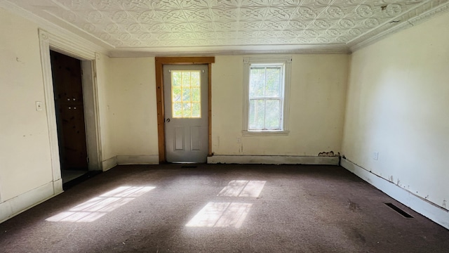 empty room with visible vents, ornamental molding, and an ornate ceiling