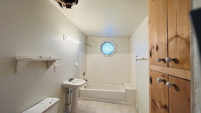 bathroom with a sink, toilet, and shower / tub combination