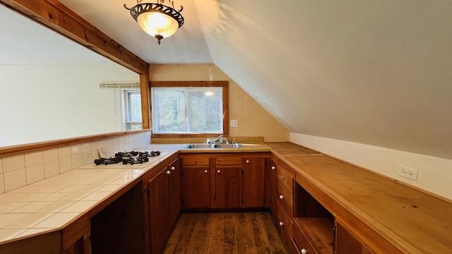 bar with lofted ceiling with beams, white gas stovetop, dark wood-type flooring, a sink, and backsplash