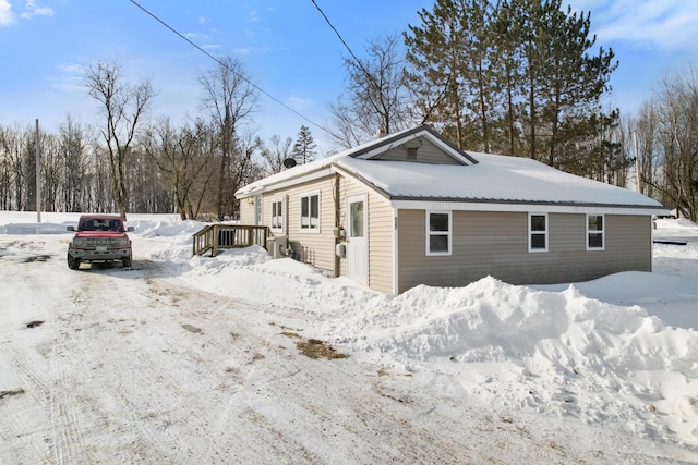 view of snow covered exterior with a wooden deck