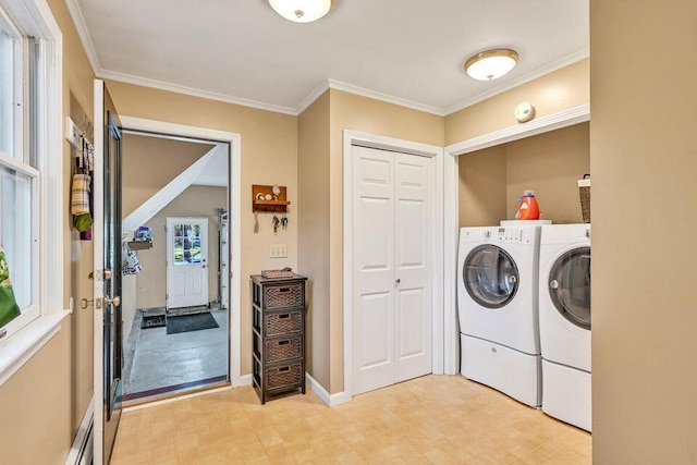 laundry room featuring laundry area, baseboards, ornamental molding, and washer and dryer