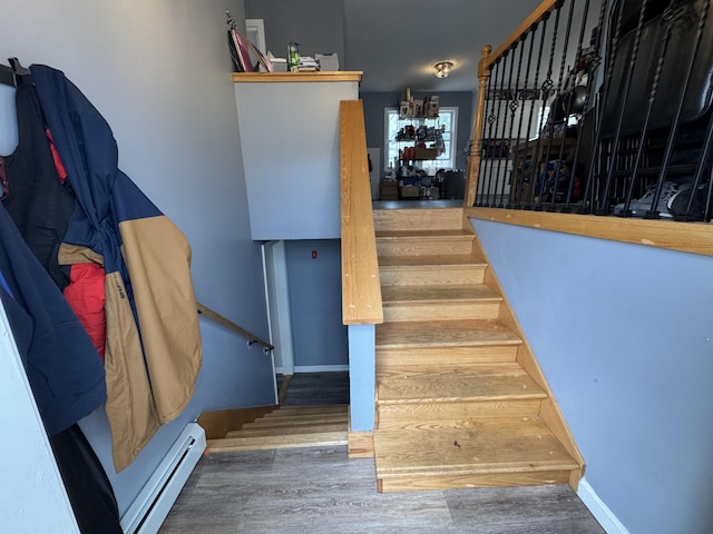 3 Jack St, Winslow, ME 04901 - stairway with a baseboard heating unit, baseboards, and wood finished floors