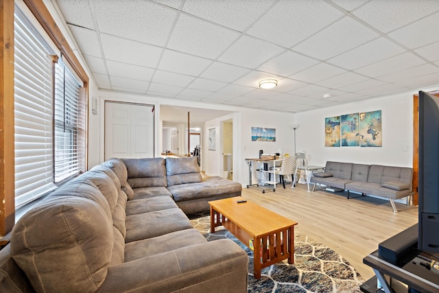 living room with wood finished floors and a drop ceiling