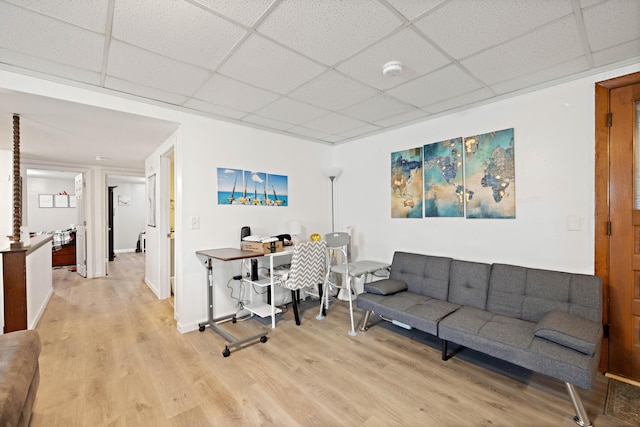 office space featuring wood finished floors, baseboards, and a paneled ceiling