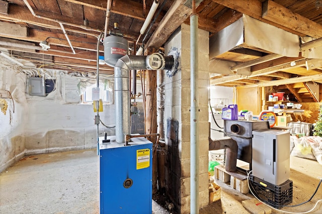 utility room with electric panel and a heating unit