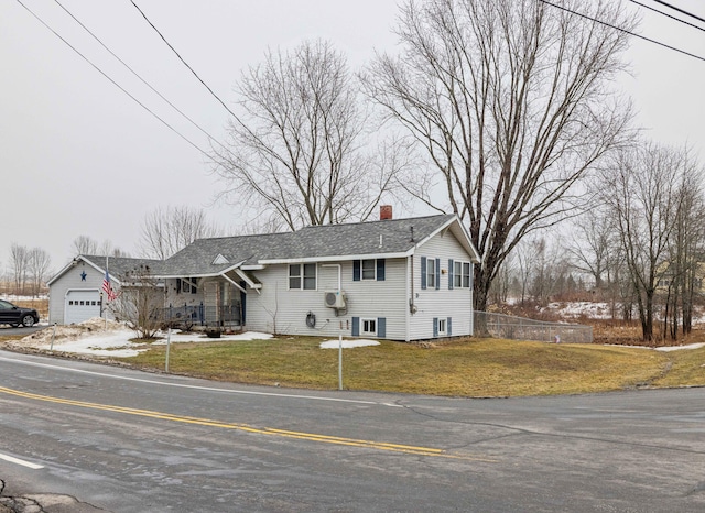 view of front of home with a front lawn, fence, roof with shingles, and a chimney