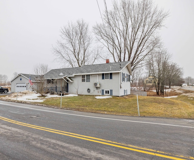 view of front of home featuring concrete driveway, a chimney, a front yard, and roof with shingles