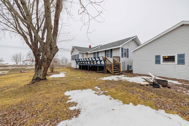 rear view of property with a wooden deck