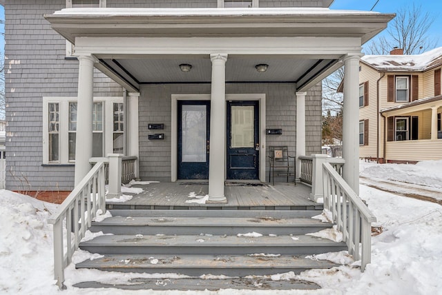 view of snow covered property entrance