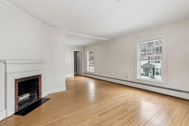 unfurnished living room featuring crown molding, a fireplace, light wood finished floors, and baseboard heating