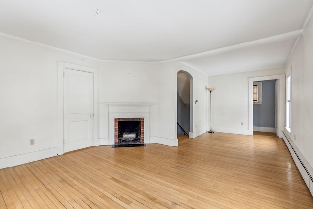 unfurnished living room with a baseboard heating unit, a brick fireplace, light wood-style flooring, and baseboards