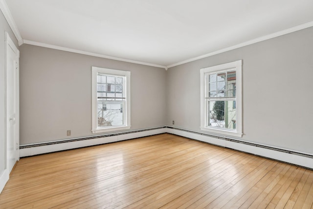 unfurnished room featuring light wood finished floors, baseboard heating, and crown molding