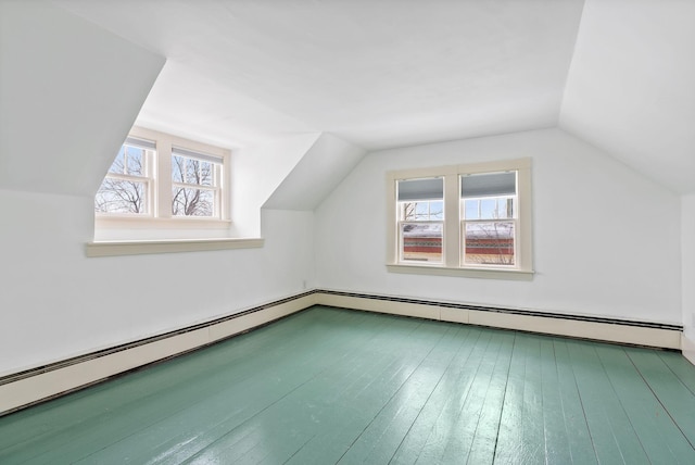 additional living space with vaulted ceiling and hardwood / wood-style floors