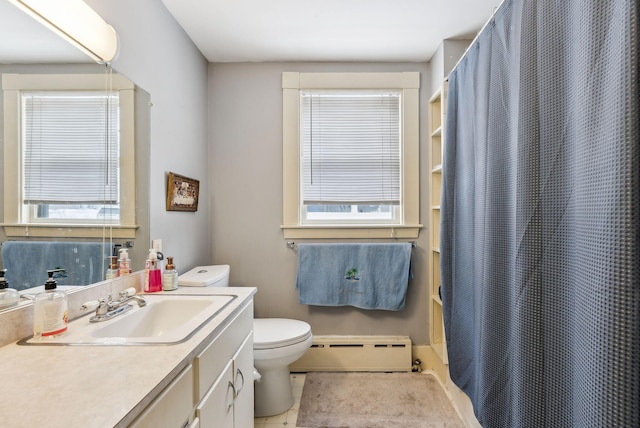 bathroom featuring toilet, vanity, baseboard heating, and tile patterned floors