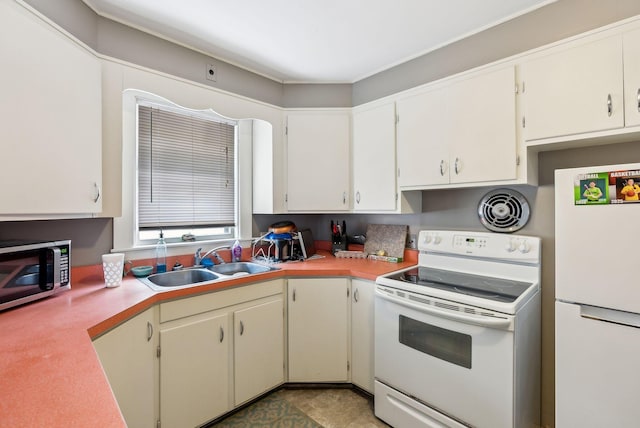 kitchen with white appliances, visible vents, light countertops, white cabinetry, and a sink