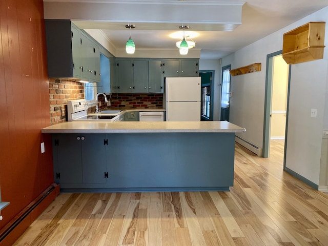 kitchen featuring a baseboard radiator, white appliances, light countertops, and a peninsula