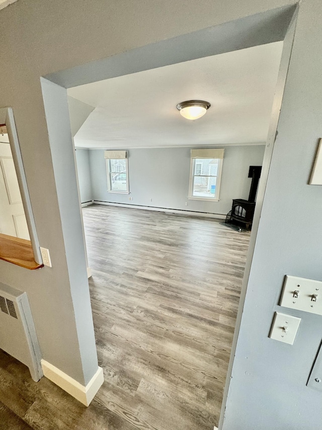 living room with radiator, wood finished floors, and baseboards