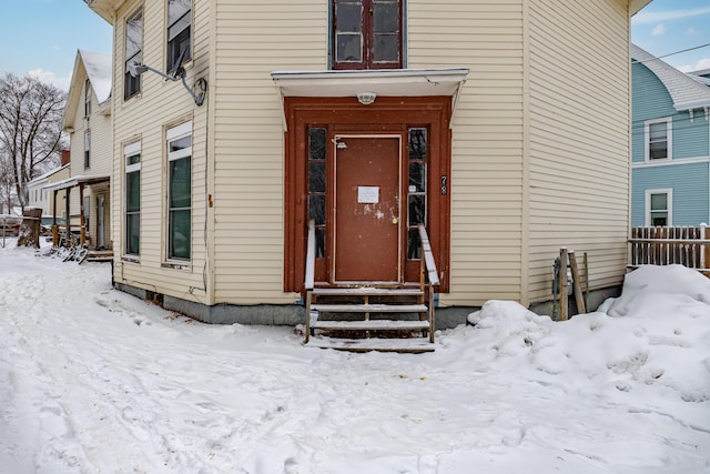 view of snow covered property entrance