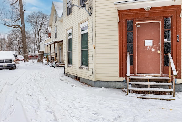 view of snow covered property entrance