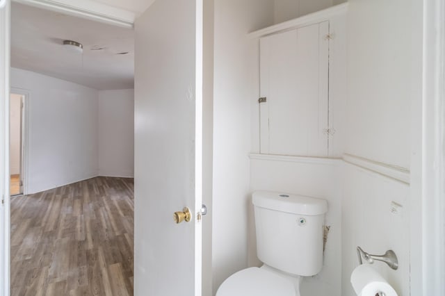 bathroom featuring toilet and wood finished floors