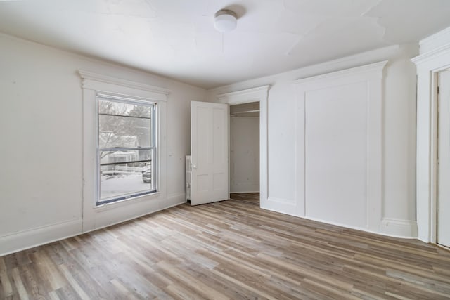 unfurnished bedroom with light wood-type flooring and baseboards