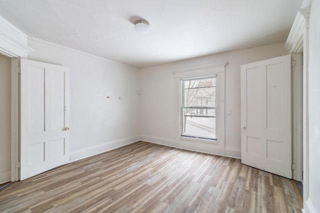 unfurnished bedroom featuring baseboards and light wood finished floors