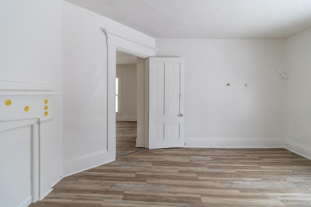 spare room with light wood-type flooring and baseboards