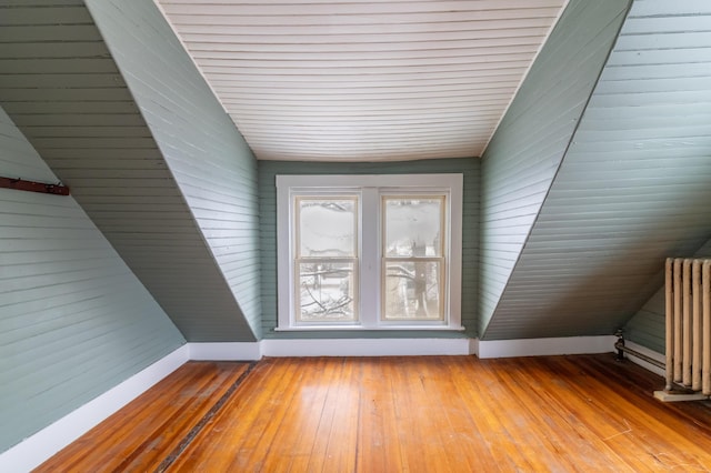 interior space with radiator, light wood-style flooring, and baseboards