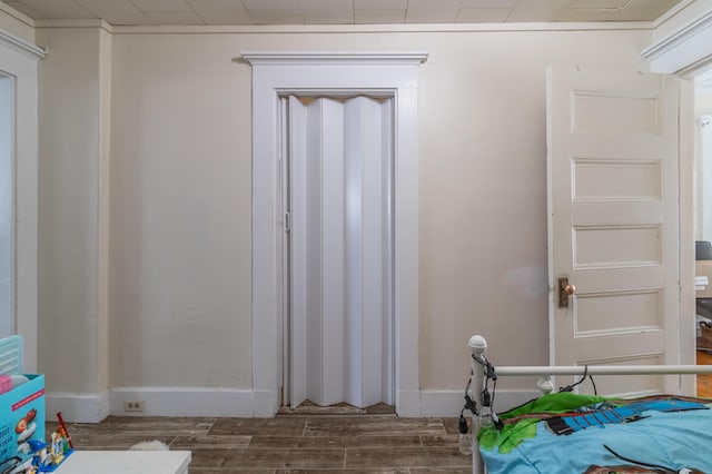 unfurnished bedroom with dark wood-type flooring and baseboards