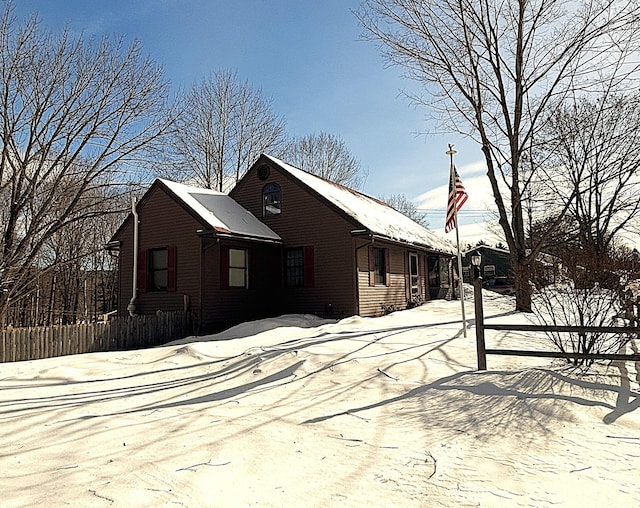 view of snow covered exterior featuring fence