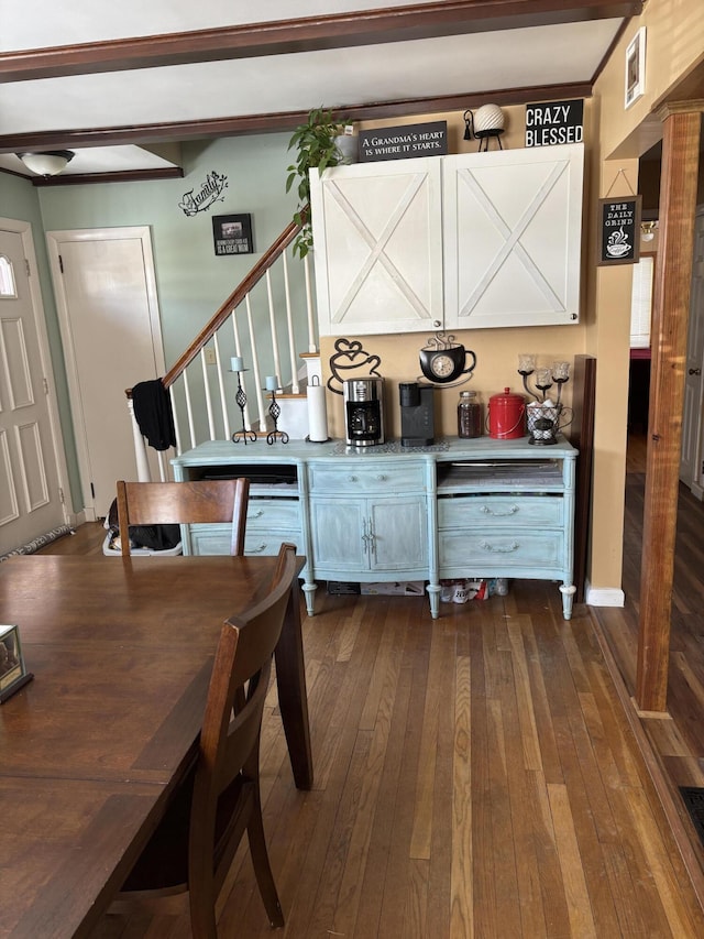 dining area featuring stairway and dark wood finished floors