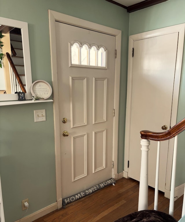 entrance foyer featuring stairs, dark wood finished floors, and baseboards