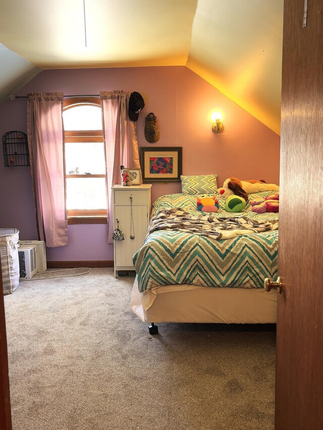 bedroom with light colored carpet, vaulted ceiling, and a wall mounted AC