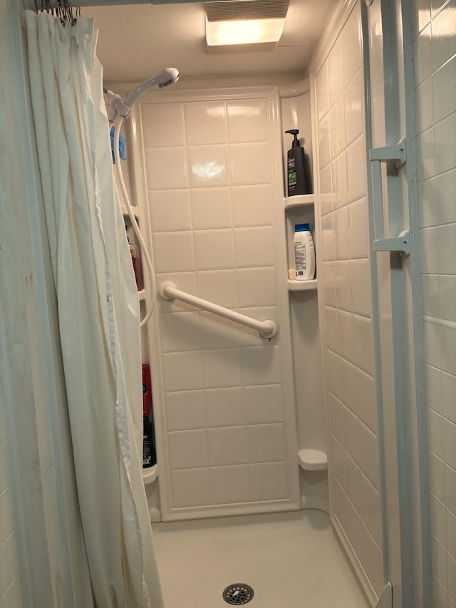 bathroom with a tile shower