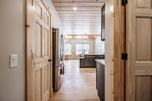 corridor featuring light wood finished floors, wood ceiling, and baseboard heating