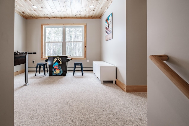 interior space featuring a baseboard heating unit, wooden ceiling, and baseboards