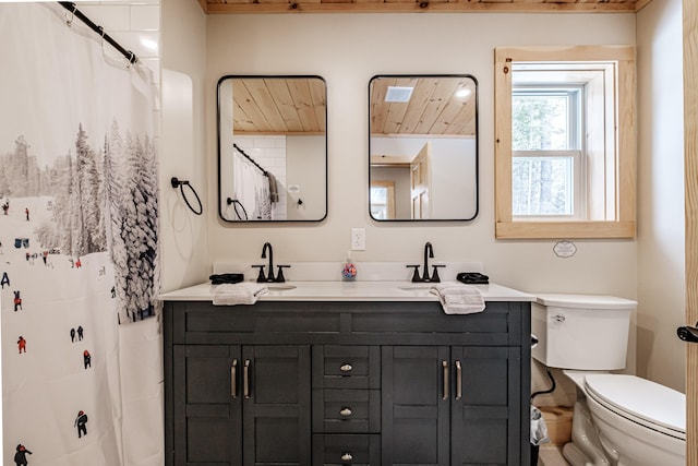 full bath featuring double vanity, a sink, and toilet