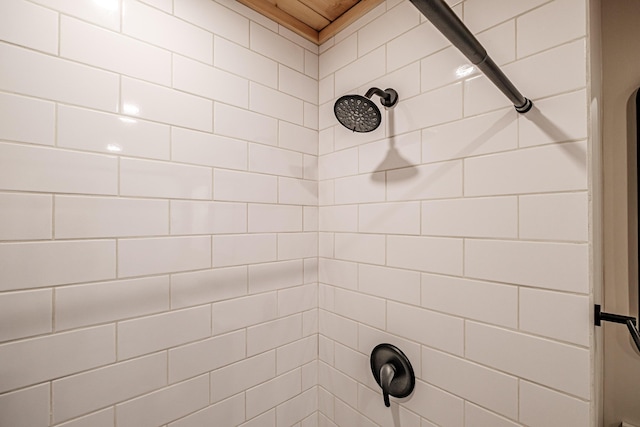 interior details featuring a tile shower